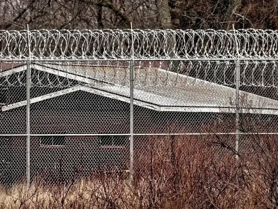 razor wire and barbed wire installed on security fence topping