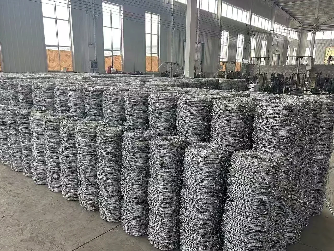 galvanized hexagonal chicken wire rolls grouped in a workshop