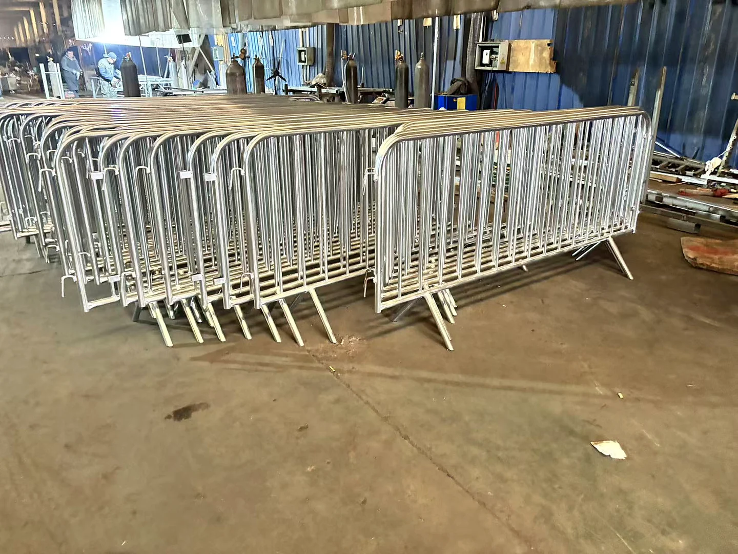 galvanized crowd control barriers arranged in a workshop