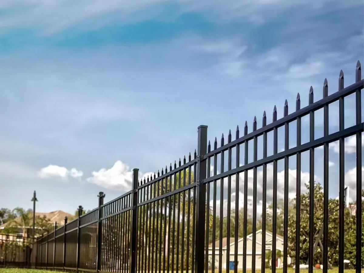 installed black tubular steel picket fence with spear tops square posts and two horizontal rails