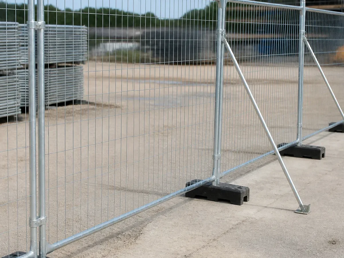 close-up of temporary fence panel feet clamp and support brace detail